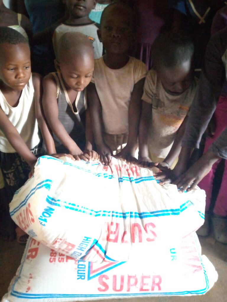 Orphans are happy about the donations, which were used to buy maize flour.